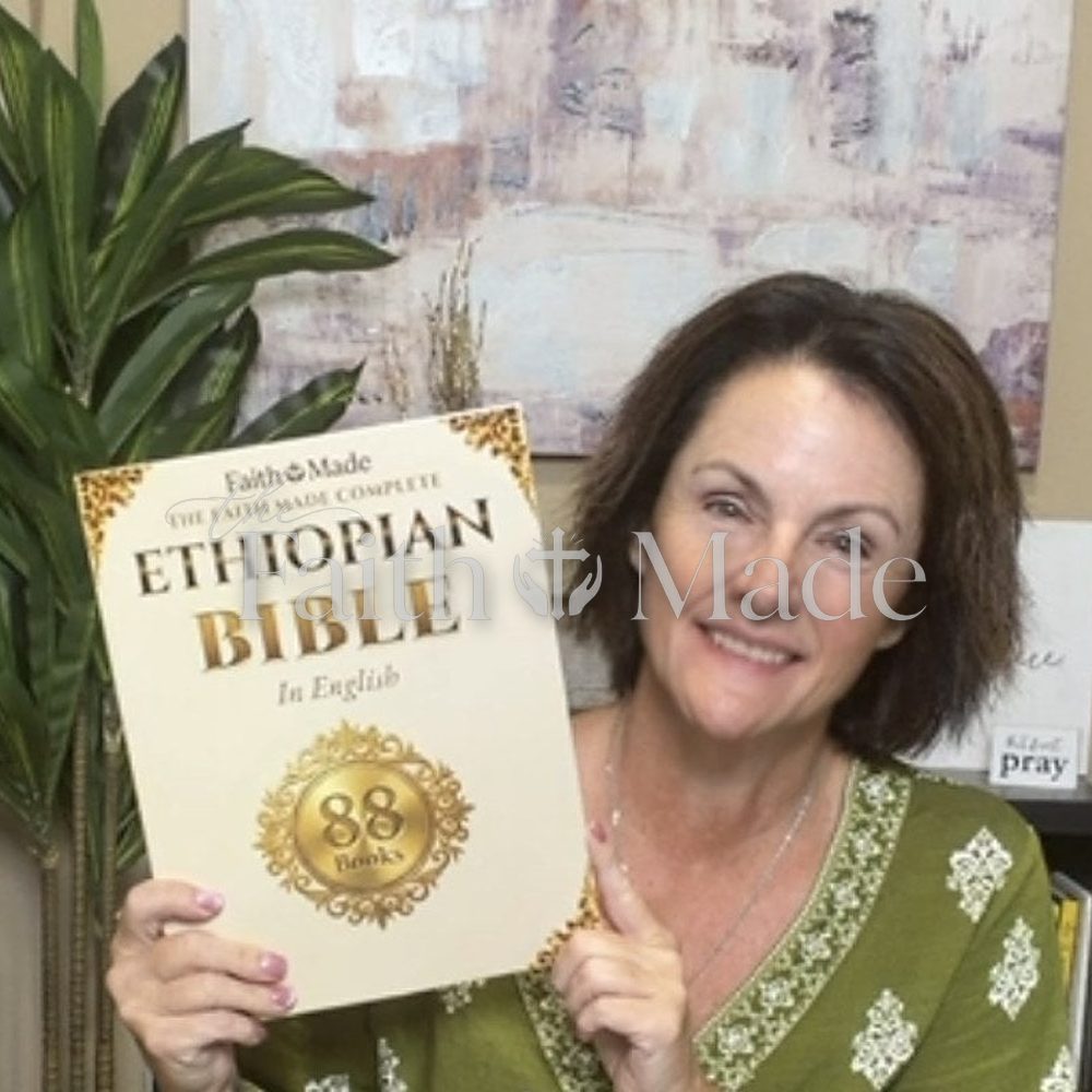 A reader holding The Faith Made Complete Ethiopian Bible